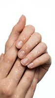 Wet hands with water droplets clasped together on white background for skincare and hygiene concepts.