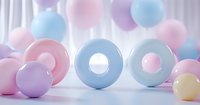 Pastel colored rings and spheres in soft pink, blue and purple tones arranged on white surface with gentle lighting, creating dreamy minimalist composition.