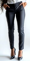 Professional woman wearing classic black tailored pants and stiletto heels against white background, showcasing modern business attire and elegant style.