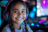 Young Hispanic girl with braids wearing pink gaming headphones smiles brightly in neon-lit room with bokeh lights, representing youth gaming and digital entertainment.