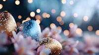 Frosted Easter eggs with glitter sparkles nestled among delicate pink spring blossoms against blurred bokeh lights creating magical holiday atmosphere.