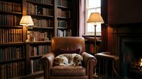 Cozy home library with leather armchair, sleeping cat, warm lamp lighting, wooden bookshelves filled with books, and fireplace creating peaceful reading atmosphere.