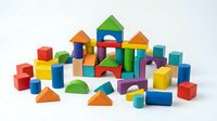 Colorful wooden building blocks set with geometric shapes including cubes, cylinders, triangles and arches for children educational play and development.
