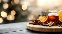 Aromatic winter drink with honey, orange, cinnamon sticks and star anise on wooden board against blurred Christmas lights background creates cozy atmosphere.