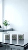 Wooden blocks with green eco-friendly symbols including wind turbine, electric car and solar panel on modern office desk for sustainable business concepts.