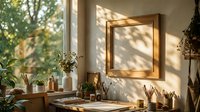 Wooden frame mockup on sunlit wall above artist desk with plants, brushes and jars, warm natural light, cozy creative studio interior.