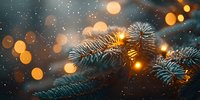 Frosty pine branches with warm golden bokeh lights creating magical winter holiday atmosphere against dark background.