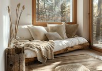 Cozy window nook with rustic wooden daybed, cream knitted pillows and throw blanket, dried pampas grass decor, perfect for hygge interior design and modern farmhouse style.