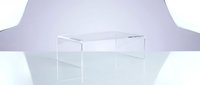 Transparent acrylic coffee table on a light studio background, showcasing modern minimalist furniture design for interior decor concepts.