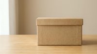 Brown cardboard storage box with lid on wooden table against neutral beige wall background for organizing home office supplies and decluttering spaces.