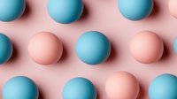 Minimalist pattern of matte spheres in coral pink and turquoise blue colors arranged in rows on pink background creating modern geometric design.