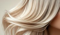 Smooth blonde hair flowing in silky waves, showcasing healthy shine and natural highlights for hair care advertising and beauty industry use.