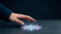 Hand of a person in dark business attire hovering over glowing digital network nodes on surface, representing technology, connectivity, innovation and data management concepts.