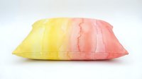 Soft gradient pillow transitioning from yellow to pink, isolated on white background, suitable for home decor, bedding, and interior design projects.