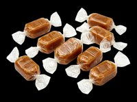 Caramel candies wrapped in clear cellophane, isolated on transparent background. Ready for design use on packaging, posters, t-shirts, stickers, and print-on-demand products.