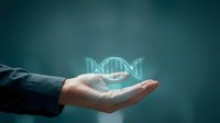 Scientist hand holding glowing DNA helix symbol against teal background, representing genetic research, biotechnology, and molecular biology innovation for scientific and medical applications.