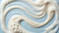 Abstract swirling foam texture with blue and white waves creating dynamic fluid motion pattern for modern design backgrounds and creative projects.