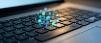 Digital network icons floating above laptop keyboard representing cloud computing and online connectivity for business technology concepts.