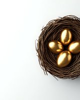 Golden eggs nestled in natural brown nest against white background, symbolizing wealth, investment and financial security.