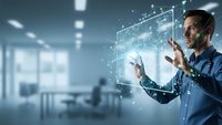 Professional businessman interacting with futuristic holographic interface displaying data analytics and digital technology in modern office environment.
