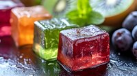 Colorful fruit-flavored ice cubes with fresh berries and kiwi slices on wet surface for summer beverages and cocktail preparation.