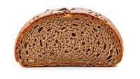 Fresh baked artisan bread slice showing detailed texture and layers isolated on white background for culinary and food design projects.