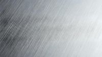 Brushed metal surface with fine linear texture and reflective finish for industrial and modern design applications.