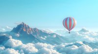 Majestic hot air balloon floating over dramatic mountain peaks and fluffy clouds at sunrise, creating dreamy atmosphere perfect for travel, adventure and inspirational designs.