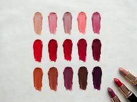 Lipstick color palette swatches in pink, red, and brown tones with gold tubes on white background for cosmetic branding and makeup artistry projects.