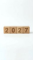 Four wooden blocks spelling 2027 arranged in a row on a white background, symbolizing new year goals, planning, and future business strategy.