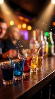 Colorful cocktails splashing on bar counter with dramatic lighting and bokeh background creating vibrant nightlife atmosphere for entertainment venues.
