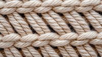 Close up macro view of beige knitted wool texture showing detailed stitch pattern and soft yarn texture. Natural fiber material background for craft and textile design.