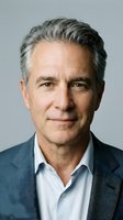 Mature man with gray hair and light skin tone wearing blue blazer and white shirt against neutral background, suitable for corporate portraits and professional headshots.