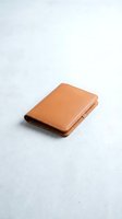 Brown leather wallet isolated on white background for product photography and commercial use.