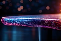 Glowing pink and blue metallic surface with sparkles and bokeh effect in dark background, creating futuristic and magical atmosphere.