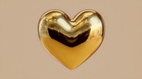 Golden metallic heart shape with glossy reflective surface on neutral background for romantic designs, Valentine's Day decorations and love concepts.