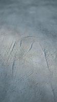 Single footprint impression in soft sand beach surface with shallow depth of field creating natural texture background for travel concepts.