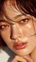 Close-up portrait of young woman with wet hair and dewy skin showcasing natural beauty and skincare routine for cosmetic and wellness campaigns.