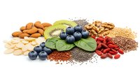 Superfood collection with nuts, berries, seeds and greens isolated on white background for healthy nutrition and wellness lifestyle concepts.
