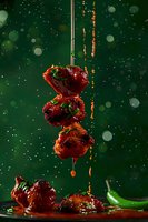 Grilled chicken kebab with spicy sauce dripping against dark green background with bokeh effect and green chili pepper, dynamic food photography.