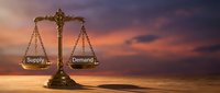 Economic balance concept with golden scales weighing supply and demand against dramatic sunset sky for business and market analysis presentations.