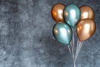 Metallic copper and teal balloons bunch against textured gray background for celebration party decoration events and festive occasions with copy space.