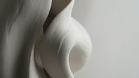 Close-up of smooth, curved white forms with soft lighting and subtle shadows, suitable for abstract art, design backgrounds, and contemporary visual projects.