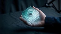 Close-up of hand holding glowing turquoise glass cube with spiral light effect, representing innovation, technology, and future concepts for business and design projects.