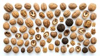 Walnuts and walnut halves isolated on white background, overhead view. Suitable for food packaging, recipe blogs, nutrition websites, and healthy eating content.