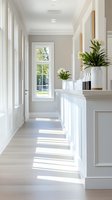Bright modern kitchen interior with white cabinets, natural light streaming through windows, and green plants creating fresh contemporary home design atmosphere.