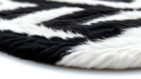 Close-up macro shot of black and white animal fur texture showing natural striped pattern with soft fluffy fibers for backgrounds and design projects.