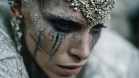 Fantasy warrior woman with silver crown and tribal face paint makeup for cosplay costume design and creative projects.