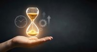 Glowing hourglass floating above open palm with clock and rocket symbols in background representing time management and productivity concepts.