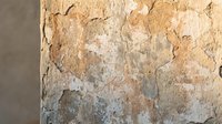 Weathered peeling paint texture on old wall surface with natural aging patina and rustic decay for vintage design backgrounds and artistic projects.